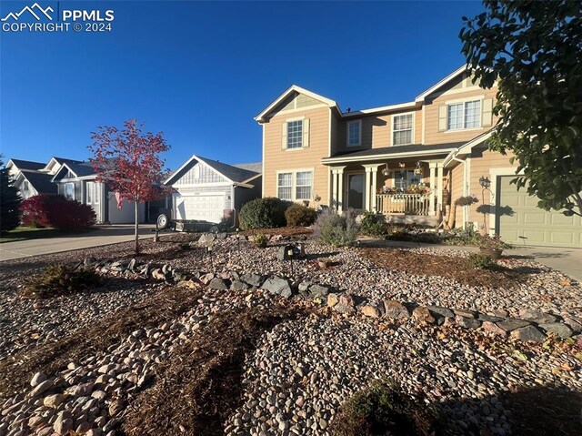 view of front of property featuring a porch and a garage