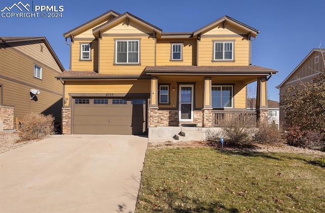 craftsman inspired home with covered porch, a front yard, and a garage