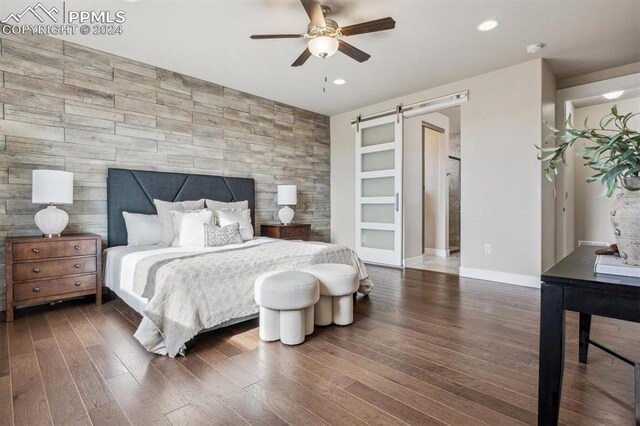 7680 Almond Wood Loop, Colorado Springs, CO 80908 - bedroom featuring an accent wall, dark wood-style floors, wooden walls, baseboards, and recessed lighting