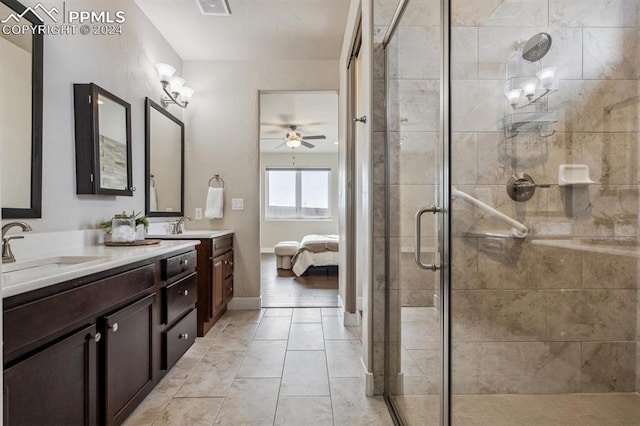 bathroom with tile patterned flooring, vanity, ceiling fan, and an enclosed shower