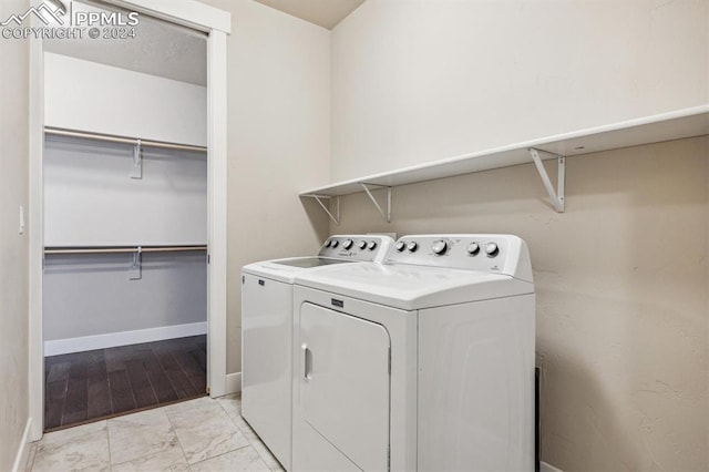 washroom with washer and dryer and light hardwood / wood-style flooring