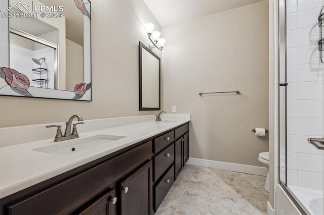 full bathroom featuring shower / bath combination with glass door, vanity, and toilet