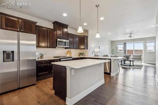 7680 Almond Wood Loop, Colorado Springs, CO 80908 - kitchen featuring stainless steel appliances, dark wood-style floors, baseboards, dark brown cabinetry, and light countertops