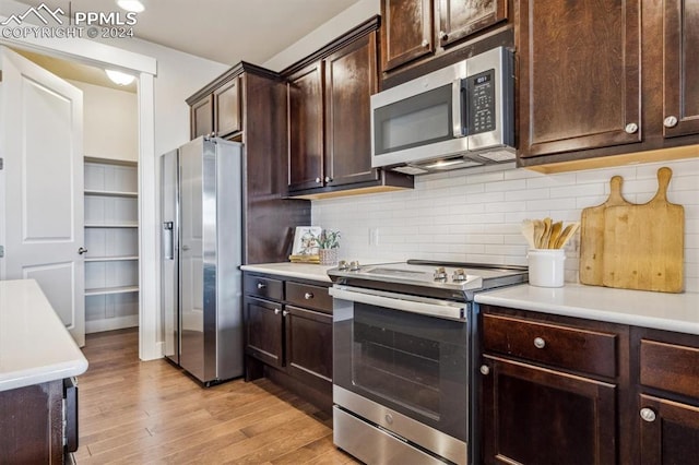 kitchen featuring decorative backsplash, dark brown cabinetry, stainless steel appliances, and light hardwood / wood-style floors