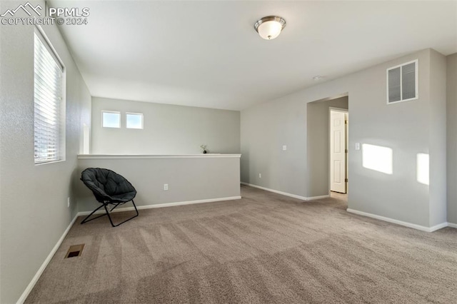 unfurnished room featuring light carpet