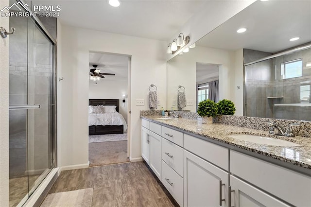 bathroom with vanity, hardwood / wood-style flooring, ceiling fan, and a shower with shower door