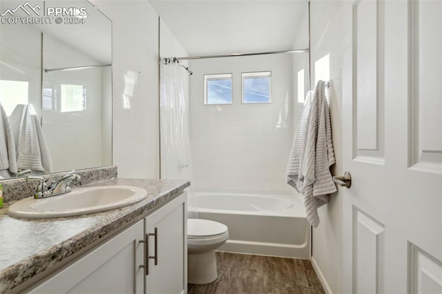 full bathroom featuring wood-type flooring, vanity, toilet, and shower / bathtub combination with curtain