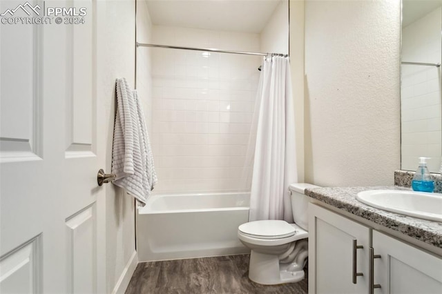 full bathroom featuring shower / bath combination with curtain, toilet, wood-type flooring, and vanity