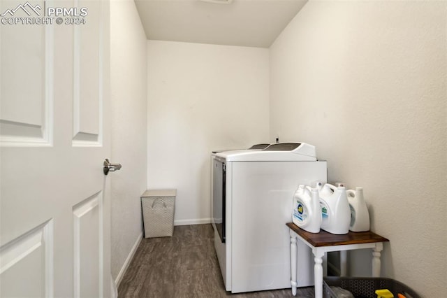 washroom with hardwood / wood-style flooring and washing machine and dryer