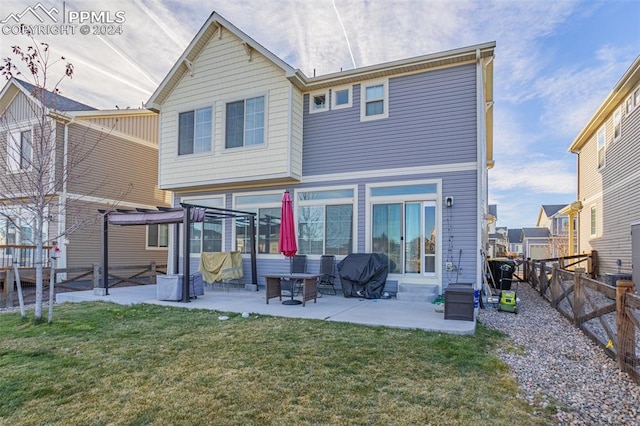 rear view of house featuring a pergola, a patio area, and a yard