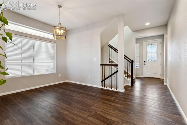 foyer featuring a chandelier and dark hardwood / wood-style floors