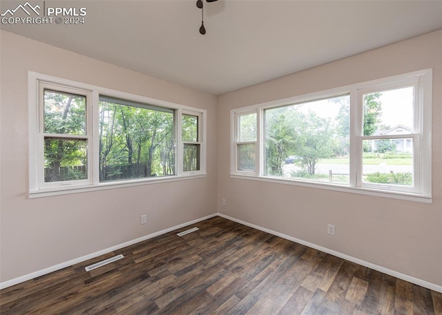 spare room with dark hardwood / wood-style flooring