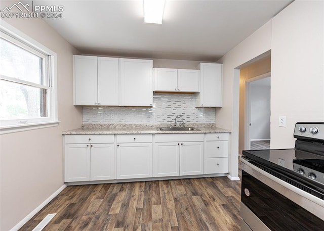 kitchen with white cabinets, dark hardwood / wood-style floors, stainless steel electric range oven, and sink