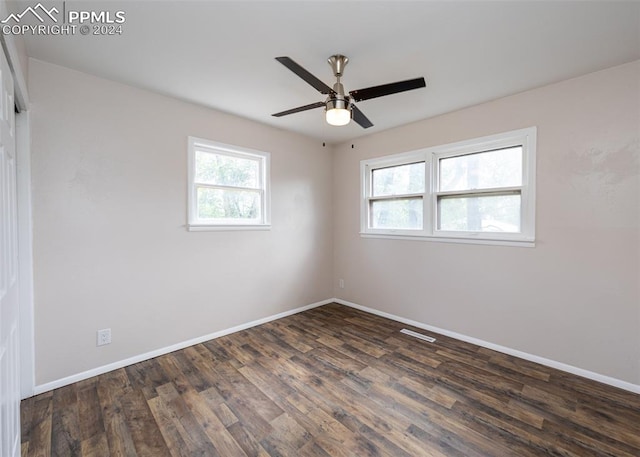 empty room featuring ceiling fan and dark hardwood / wood-style floors