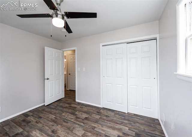 unfurnished bedroom featuring ceiling fan, dark wood-type flooring, and a closet