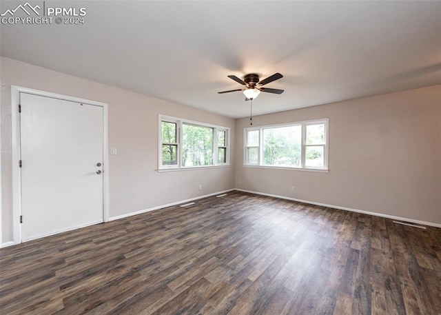 empty room with ceiling fan and dark hardwood / wood-style floors