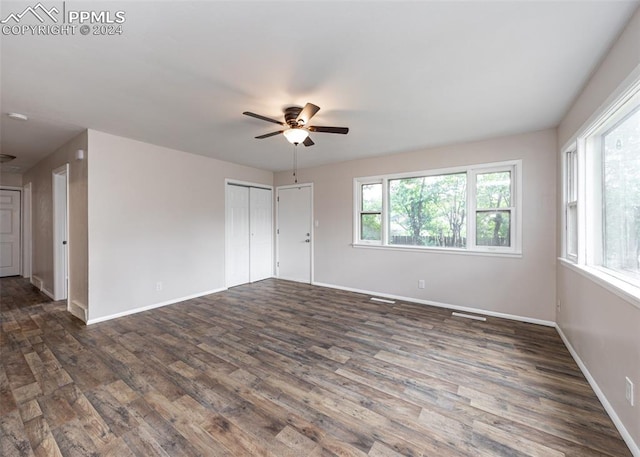 empty room featuring dark hardwood / wood-style floors and ceiling fan