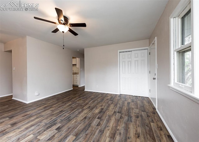 interior space with ceiling fan and dark wood-type flooring