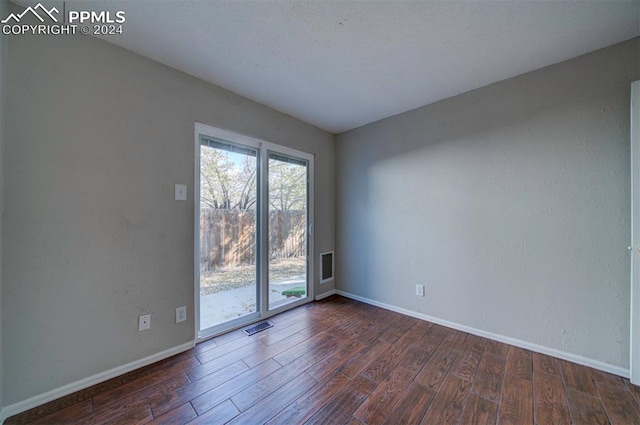 unfurnished room featuring dark hardwood / wood-style floors