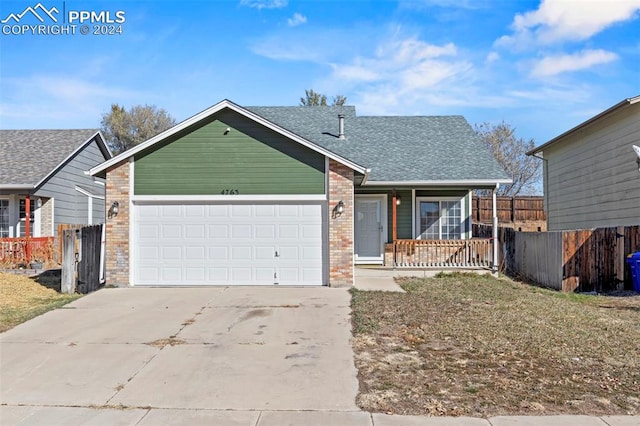 single story home with a porch and a garage