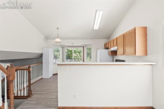 kitchen with light hardwood / wood-style flooring, white refrigerator, kitchen peninsula, pendant lighting, and vaulted ceiling