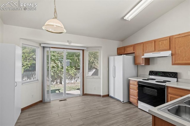 kitchen featuring lofted ceiling, white appliances, decorative light fixtures, and light hardwood / wood-style floors