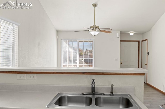 kitchen with ceiling fan, light hardwood / wood-style floors, and sink