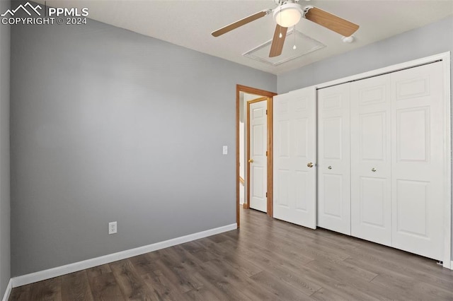 unfurnished bedroom with hardwood / wood-style flooring, ceiling fan, and a closet