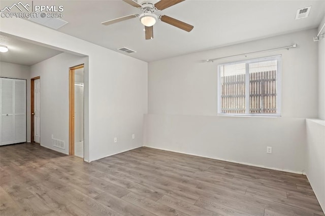 unfurnished room featuring ceiling fan and light hardwood / wood-style flooring