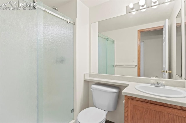 bathroom featuring vanity, toilet, and walk in shower