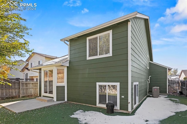 rear view of house with a patio area and central air condition unit