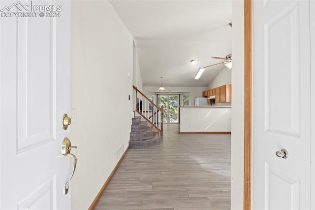 entrance foyer featuring ceiling fan, light hardwood / wood-style flooring, and lofted ceiling