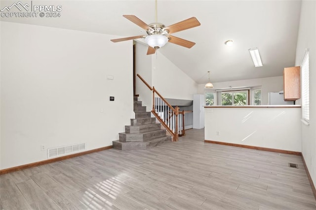 unfurnished living room featuring ceiling fan, light hardwood / wood-style flooring, and vaulted ceiling