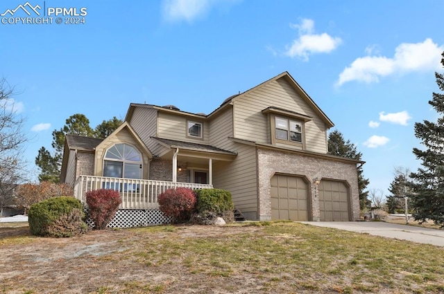 front facade with a porch, a garage, and a front lawn