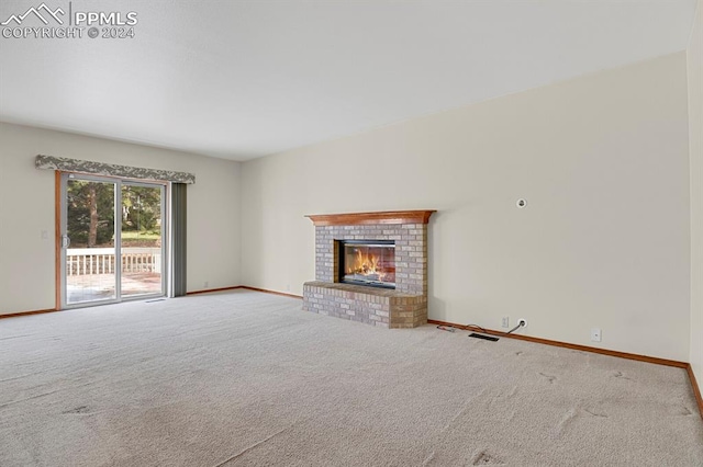 unfurnished living room featuring carpet flooring and a fireplace