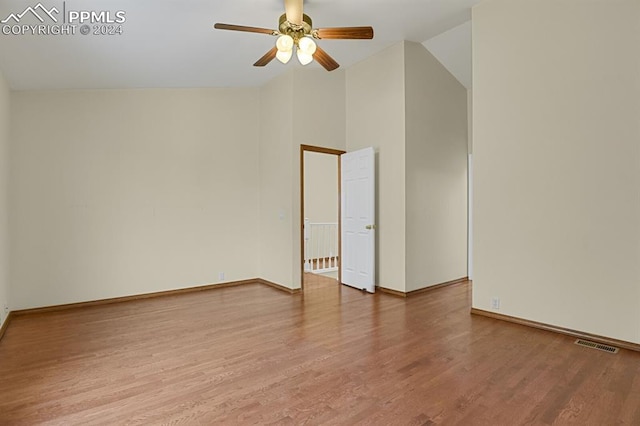 unfurnished room with hardwood / wood-style floors, high vaulted ceiling, and ceiling fan