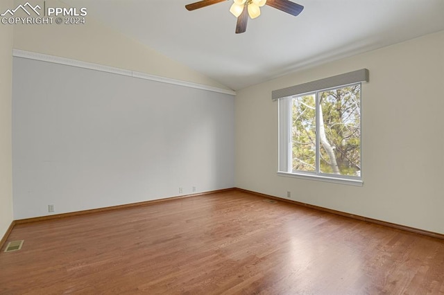 unfurnished room featuring ceiling fan, hardwood / wood-style floors, and vaulted ceiling