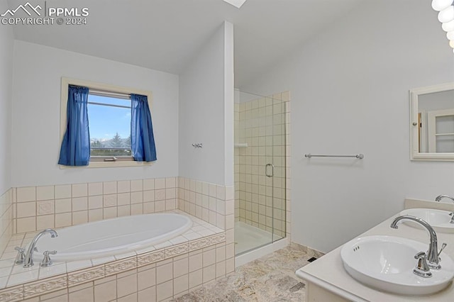 bathroom with vanity, independent shower and bath, and vaulted ceiling