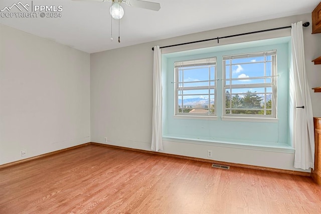 unfurnished room with ceiling fan and light hardwood / wood-style floors