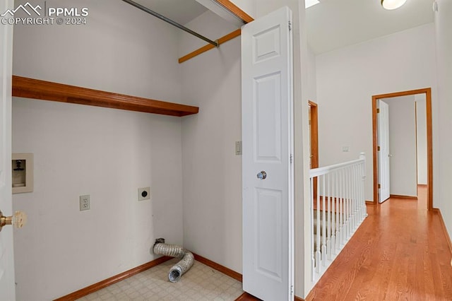 washroom featuring electric dryer hookup and light wood-type flooring