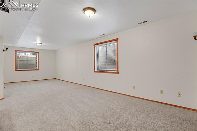 empty room featuring light carpet