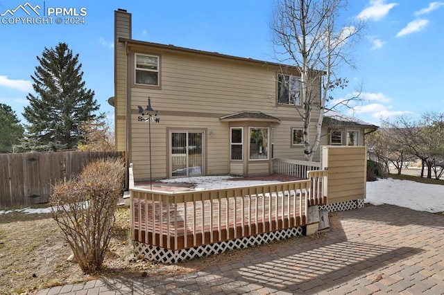 back of property with a wooden deck