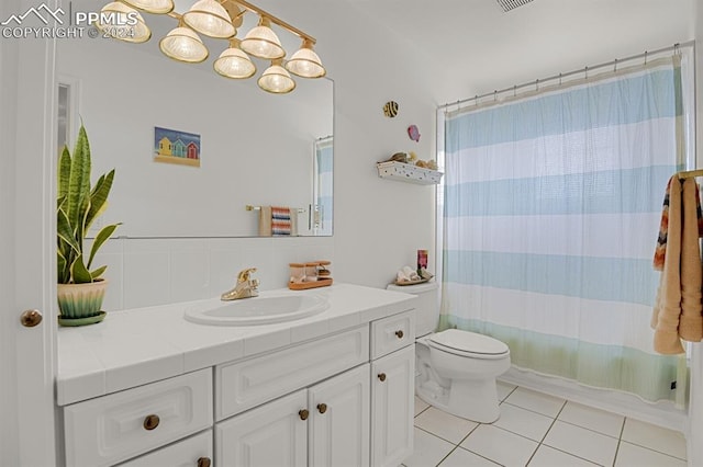 full bathroom with tile patterned flooring, vanity, shower / tub combo, and toilet