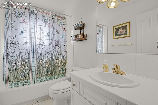 full bathroom with vanity, shower / tub combo with curtain, tile patterned floors, and toilet