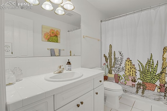 bathroom with tile patterned flooring, vanity, backsplash, and toilet