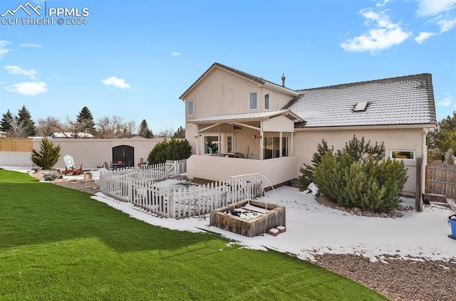 rear view of property featuring a lawn