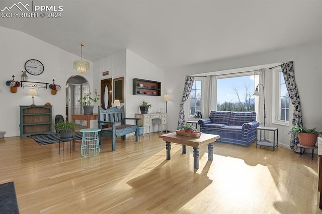 living room featuring hardwood / wood-style flooring and vaulted ceiling