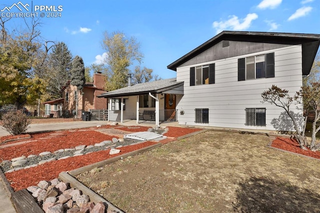 rear view of property featuring a porch