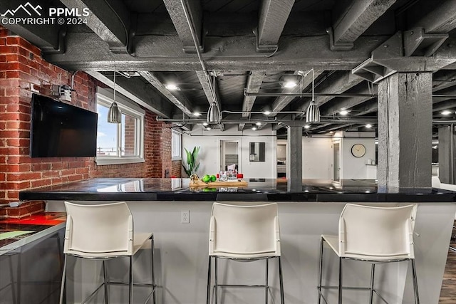 bar featuring brick wall and wood-type flooring