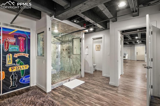 bathroom featuring hardwood / wood-style floors, toilet, and walk in shower